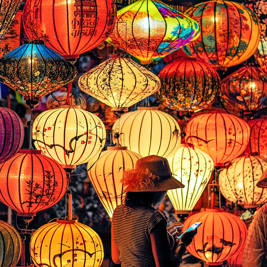Two Person Standing Near Assorted-color Paper Lanterns